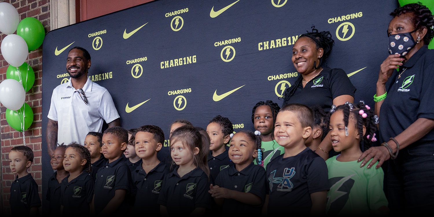 Teachers and students gathered in front of the school building